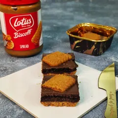 A close look at my popular Crusty Biscoff Brownie. This decadent treat features a fudgy brownie base layered with rich Biscoff spread and topped with a signature Lotus biscuit, making it a favorite for gift boxes.