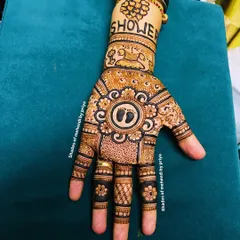 A classic baby shower design with tiny footprints at the center of a mandala. The wristband has the word 'Shower' and a drawing of a cradle.