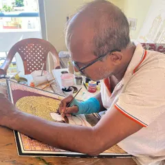 The artist in his element. My father, Raghavendra B.B., in his work mode, meticulously adding details to a painting.