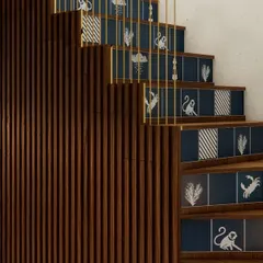 We love to infuse personality into every detail. The staircase in HAUS 5 features custom-printed Nicobar tiles on the risers, turning a functional element into a delightful artistic statement that connects the two levels of the duplex.