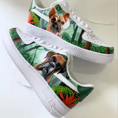 A full view of the custom pet portrait sneakers. One shoe features a boxer and the other a French bulldog, both set against a coordinated jungle background.