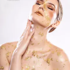 A close-up from our gold foil beauty shoot, focusing on the model's serene expression. This image highlights our ability to create artistic and emotive beauty portraits for editorial features.