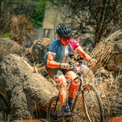 It's not just about speed, it's about skill. A rider expertly navigates a challenging rock garden section during one of our MTB XCO races, demonstrating the technical terrain we offer.