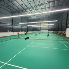 A wide view of our new, well-lit courts at the Rackonnect Pro Badminton Arena in Ghaziabad. We ensure consistent, high-quality lighting for an optimal playing experience, day or night.