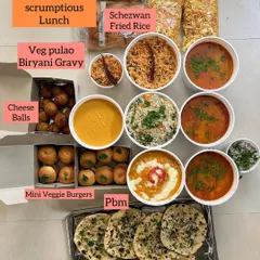 A scrumptious lunch order featuring a mix of Indian and Indo-Chinese dishes. This spread included Veg Pulao, Schezwan Fried Rice, Misal Pav, Paneer Butter Masala, Butter Kulcha, and Mini Veggie Burgers.