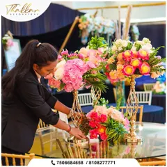 A member of my team carefully arranging a floral centerpiece. I ensure every single detail is perfect, from the placement of each flower to the final look of the table.