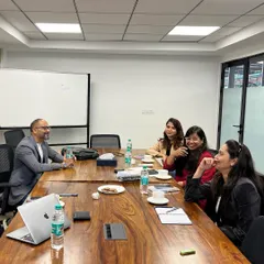 A candid moment of discussion during a professional development workshop. Creating a relaxed atmosphere encourages open dialogue and peer to peer learning among professionals.