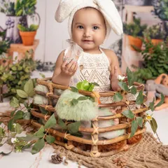 My cutest little bunny baby, surrounded by lush greenery. The soft textures and natural elements in this setup create a gentle and dreamy portrait for this one-year-old.
