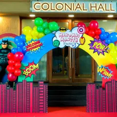 Welcome, heroes. This comic-book-style entrance arch features life-sized Batman and Spiderman figures, a red carpet, and city skyline cutouts to transport guests into the world of superheroes.