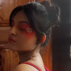 A side profile of the red heart makeup look. This angle shows how the rhinestone heart catches the light and becomes the focal point of the makeup.