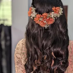For Rashi's wedding, we did soft loose curls adorned with a beautiful arrangement of fresh orange and white flowers.