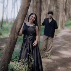 A lovely, candid shot of the bride-to-be, with her partner in the soft-focused background. This style of portrait adds depth and a storytelling element to the photo.