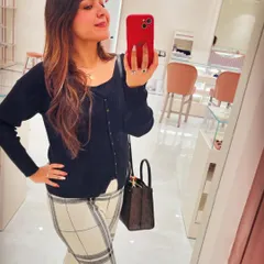 A classic office look featuring a black knit top from Lifestyle and checkered woollen trousers from GK-1 market. This shows how you can mix high-street brands with market finds for a smart, formal outfit.