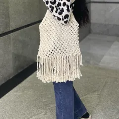A side view of the macrame tote bag. The open-knot design makes it lightweight, but the cotton thread is very strong, so you can carry a lot in it.