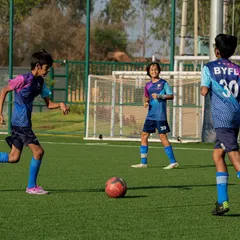 Teamwork makes the dream work, even at a young age. Our players learn to communicate and move together on the pitch during a practice game, developing their understanding of space and positioning.