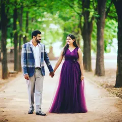 A classic romantic walk captured during a pre-wedding shoot. The couple looks so happy, and the purple tulle gown adds a perfect pop of color to the natural green backdrop.
