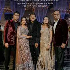 Wardrobe planning for the family. For this cocktail soirée, we styled the family in a sophisticated palette of black, deep red velvet, and shimmering metallics, creating a look of coordinated glamour.