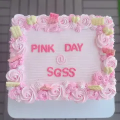 A large rectangular cake for a "Pink Day" celebration at a corporate office, with beautiful pink rosette piping.