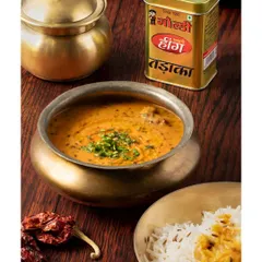 This image for Goldiee Masale captures the essence of a comforting Indian meal. The traditional brass bowls and rich colors of the dal and spices create a warm, inviting photo that speaks to home-cooked goodness.