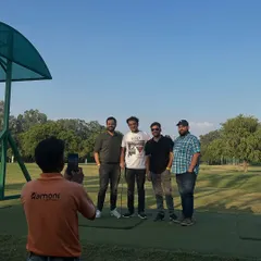 Making memories on the range. A staff member captures a moment for a group of friends enjoying their day out, perfect for a birthday or a casual get together.