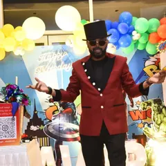 Posing in front of an incredible superhero backdrop. I love when the party theme is full of action and adventure, and I bring that same energy to my magic show.