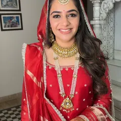 Rashmi looked absolutely radiant for her Anand Karaj. I created a classic look with defined eyes and a flawless base to complement her traditional red suit and beautiful jewelry.
