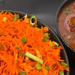 A classic combination of vibrant Schezwan fried rice served with a side of delicious Manchurian gravy. A perfect comfort meal for any day.