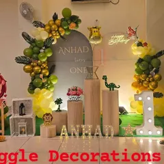 This wide-angle view showcases a grand jungle theme birthday party. The setup includes a custom backdrop, marquee number 'ONE', life-sized animal props like a lion and tiger, and organic balloon garlands to create an immersive safari experience.