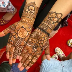 This design is a beautiful mix of floral and peacock motifs. A large rose is the centerpiece on one palm, while a peacock adorns the other, both surrounded by dense, detailed patterns.