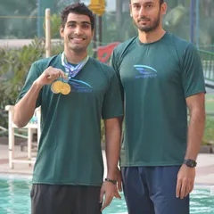 Aaryan Bhosale with Coach Virdhawal Khade after a successful championship. We foster a close working relationship between our coaches and swimmers.