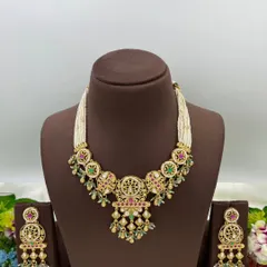An antique-style necklace set with intricate detailing and multi-color stones, shown from different angles.