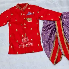 A festive red sherwani-style kurta for boys. The kurta has delicate gold embroidery, an elephant motif, and is paired with a purple printed dhoti.
