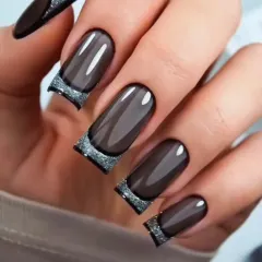 A modern take on classic elegance. This design features a translucent "glass" effect on square-tipped extensions, finished with a dramatic, sparkling silver glitter French tip. It's a chic and contemporary style for those who love a sophisticated edge.