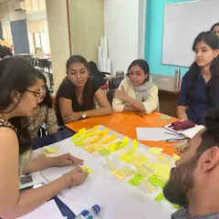 Mentorship is a dialogue. Here, I am guiding a group of urban design students through a policy-making exercise, using maps and sticky notes to visualize complex ideas. Our workshops are interactive sessions focused on collaborative problem solving and co-creation.