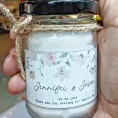 A close-up of a scented jar candle I made as a wedding favor. I can print your names, wedding date, and a thank you message on a custom label, making it a memorable return gift for your guests.