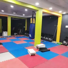 The open space in our gym, featuring a heavy bag and matted floors, is perfect for functional fitness, agility drills, and kickboxing practice.