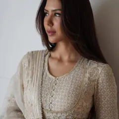 Sonam Bajwa embodies grace in this ethereal chikankari anarkali by Tarun Tahiliani. The intricate threadwork and flowing silhouette make it a masterpiece of Indian couture.