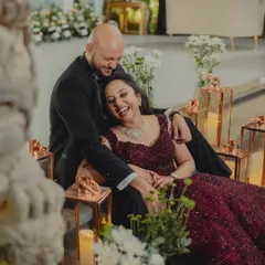 A moment of pure, uninhibited laughter between the couple during their reception. Surrounded by candles, this candid shot is full of warmth, joy, and genuine connection.