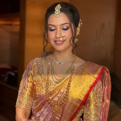 This serene shot focuses on the eye makeup, a soft blend of pink and shimmer that enhances the eyes without overpowering the traditional look. You'll learn to customize eyeshadow to suit every bride.