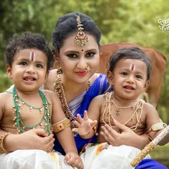 A mother's love for her two little Krishnas, captured in a beautiful outdoor setting. I love creating these special Janmashtami portraits for families with twins.