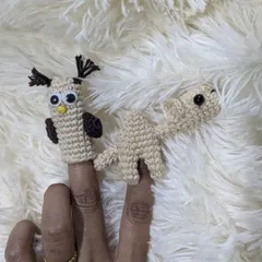 A pair of handmade finger puppets, an owl and a camel, ready for story time.