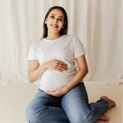 A relaxed and comfortable pose, this image captures the pure, simple joy of waiting for your little one.
