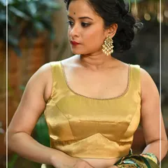 A classic sleeveless golden blouse with a scoop neckline, perfect for pairing with a rich Kanjivaram saree.