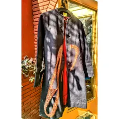 I love blending history with modern fashion. For this piece, I took a 400-year-old antique Jamevar patch and carefully stitched it onto a navy woollen coat. This is upcycling at its finest, creating a truly unique garment with a rich story.