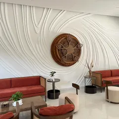 The completed masterpiece. This wide shot shows how the finished relief sculpture transforms the entire living area, creating a powerful and elegant focal point that feels like a natural extension of the architecture.