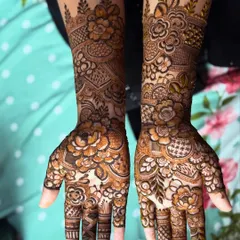 A lovely floral henna design for a party. It covers the hands beautifully, making it a great choice for guests who want something special.