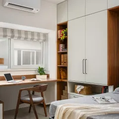 This home office from our 'Palaash' project is designed for productivity and flexibility. It features a long study desk, ample storage, and a hidden Murphy bed that transforms the space into a guest room when needed.