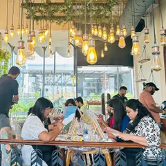 A wide shot of a workshop in a cafe with beautiful industrial-style lighting. The atmosphere of the venue plays a huge role in the overall experience.