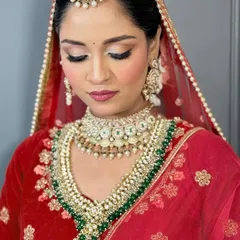 A detailed shot of the eye makeup for a classic red bridal look. I used a soft, shimmery shadow on the lids with a defined crease and liner to make the eyes pop, while keeping the overall look elegant and not overpowering.