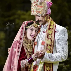 This portrait captures the beautiful bond between the couple, dressed in traditional Himachali wedding attire. The groom's embrace feels both protective and loving.